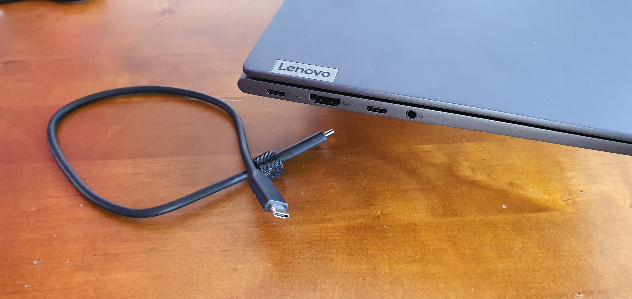 USB-C cable next to close up of USB-C ports on the Lenovo Yoga Slim 7